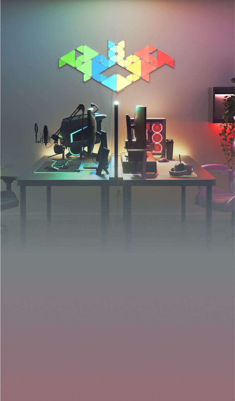 Impostazione da ufficio in camera da letto con le luci RGB Nanoleaf Lines montate sopra la scrivania e il monitor. Le luci da gaming ideali per illuminare la tua postazione da gioco per PC.