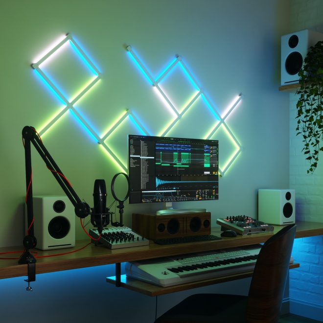 Distribución de la habitación y la oficina con las luces RGB Nanoleaf Lines instaladas sobre el escritorio y el monitor. Las luces de juego perfectas para tu puesto de combate: tu PC.